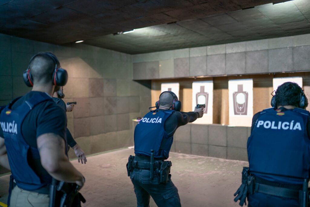 Police training in shooting gallery with short weapon.